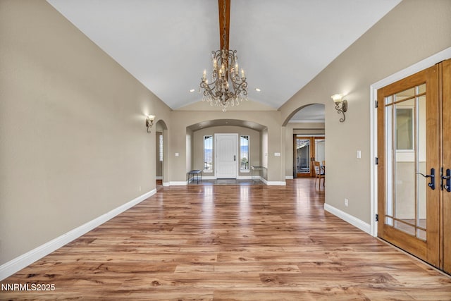 227 S Earlham, Reno, NV 89511 - foyer with arched walkways, light wood-type flooring, a chandelier, high vaulted ceiling, and french doors