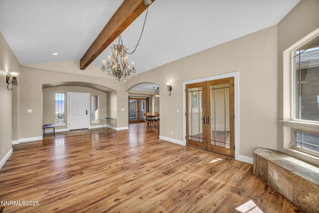 227 S Earlham, Reno, NV 89511 - unfurnished living room featuring arched walkways, french doors, light wood-style floors, baseboards, and recessed lighting