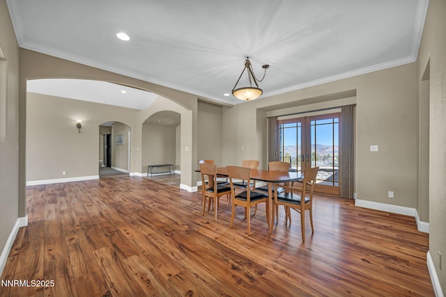 227 S Earlham, Reno, NV 89511 - dining space with arched walkways, hardwood / wood-style flooring, crown molding, and baseboards