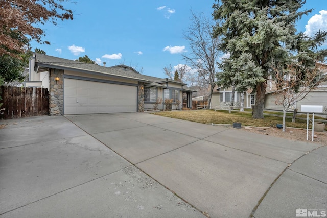 1663 Shadow Wood Ct, Reno, NV 89523 - view of front facade featuring stone siding, an attached garage, and driveway