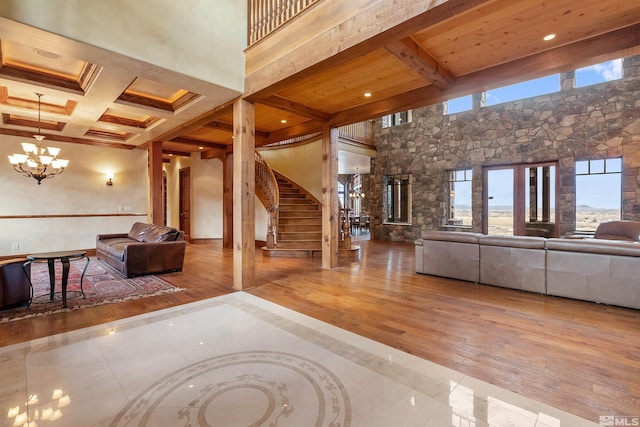 525 Cable Canyon Way, Fernley, NV 89408 - unfurnished living room with a chandelier, beam ceiling, wood finished floors, stairway, and coffered ceiling
