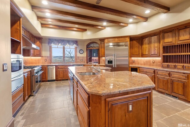 525 Cable Canyon Way, Fernley, NV 89408 - kitchen with premium appliances, under cabinet range hood, brown cabinetry, a warming drawer, and beamed ceiling