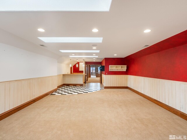 525 Cable Canyon Way, Fernley, NV 89408 - empty room featuring a skylight, a wainscoted wall, carpet, and recessed lighting