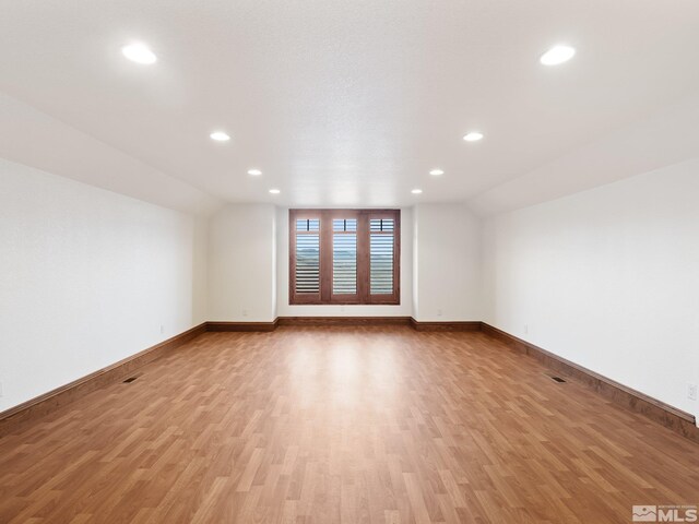 525 Cable Canyon Way, Fernley, NV 89408 - additional living space with light wood-type flooring, recessed lighting, baseboards, and lofted ceiling