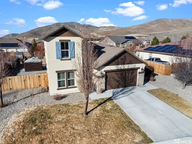 2780 Tobiano Dr, Reno, NV 89521 - view of front of home featuring driveway, stucco siding, a mountain view, fence, and an attached garage