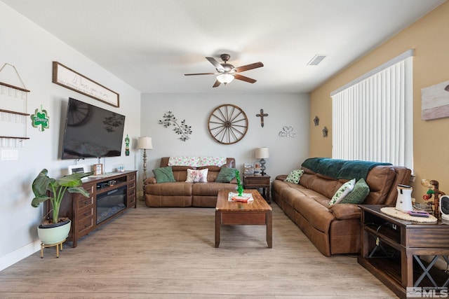 2780 Tobiano Dr, Reno, NV 89521 - living room featuring a ceiling fan, light wood-style flooring, and baseboards