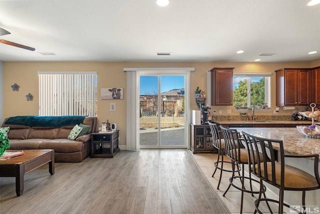 2780 Tobiano Dr, Reno, NV 89521 - living room featuring light wood finished floors, ceiling fan, and recessed lighting