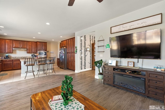 2780 Tobiano Dr, Reno, NV 89521 - living area featuring a ceiling fan, light wood finished floors, recessed lighting, and baseboards