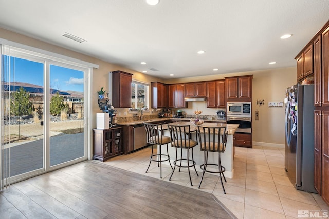 2780 Tobiano Dr, Reno, NV 89521 - kitchen featuring appliances with stainless steel finishes, a kitchen breakfast bar, a kitchen island, a sink, and recessed lighting