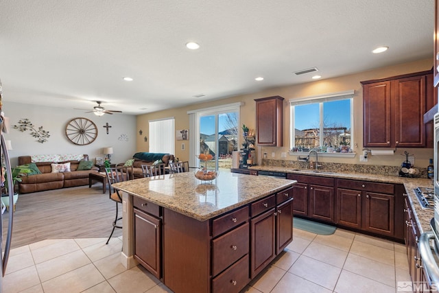 2780 Tobiano Dr, Reno, NV 89521 - kitchen with a sink, open floor plan, light tile patterned flooring, a center island, and light stone counters