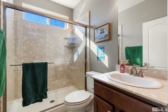 2780 Tobiano Dr, Reno, NV 89521 - bathroom with a shower stall, toilet, a textured wall, and vanity