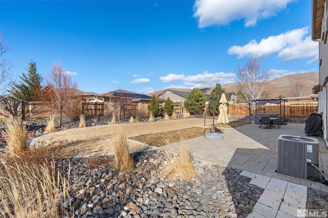 2780 Tobiano Dr, Reno, NV 89521 - view of patio / terrace with central air condition unit, a fenced backyard, and outdoor dining area