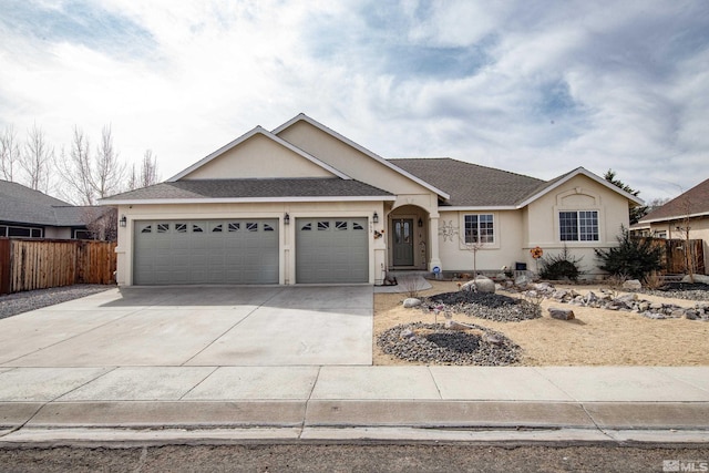 953 Julia Ln, Fernley, NV 89408 - ranch-style home with a garage, driveway, stucco siding, fence, and roof with shingles