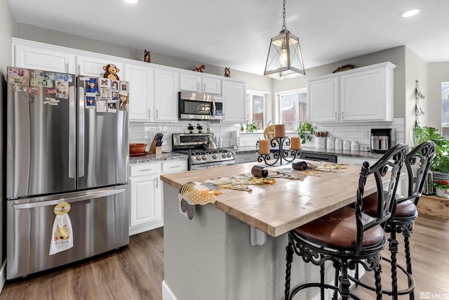 953 Julia Ln, Fernley, NV 89408 - kitchen featuring appliances with stainless steel finishes, wooden counters, backsplash, a center island, and recessed lighting