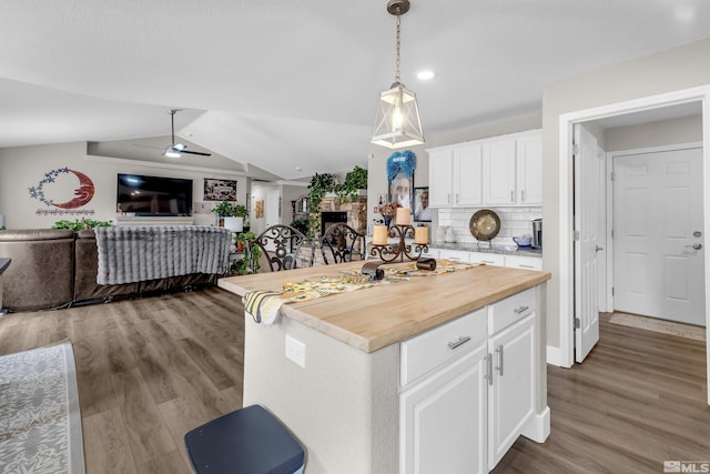 953 Julia Ln, Fernley, NV 89408 - kitchen with open floor plan, wood finished floors, ceiling fan, white cabinetry, and pendant lighting