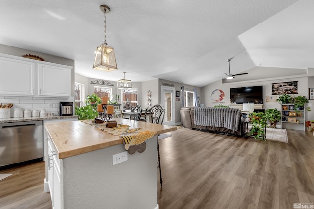 953 Julia Ln, Fernley, NV 89408 - kitchen featuring stainless steel dishwasher, open floor plan, white cabinets, light wood-style flooring, and wood counters