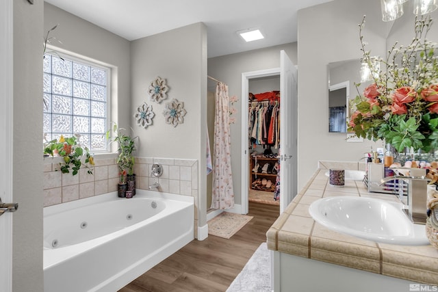 953 Julia Ln, Fernley, NV 89408 - bathroom with a shower stall, wood finished floors, a whirlpool tub, and vanity