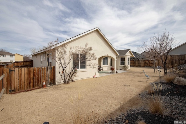 953 Julia Ln, Fernley, NV 89408 - back of house featuring a fenced backyard, a patio area, and stucco siding