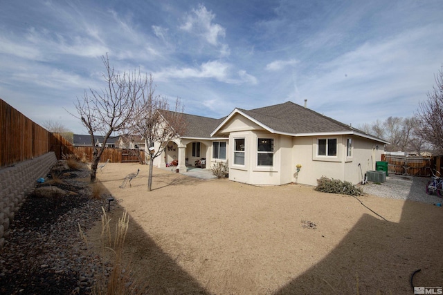 953 Julia Ln, Fernley, NV 89408 - rear view of property with a fenced backyard, roof with shingles, central air condition unit, and stucco siding