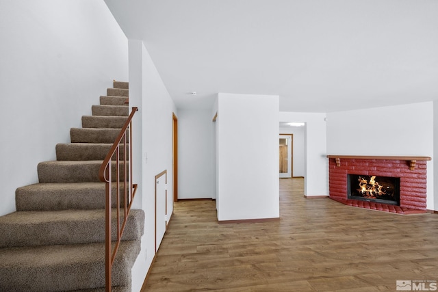 857 Cherry Tree Dr Unit 3, Sparks, NV 89434 - unfurnished living room with stairs, wood finished floors, a fireplace, and baseboards