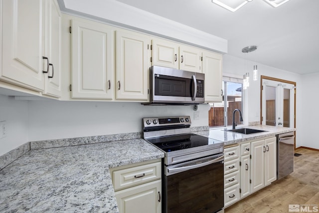 857 Cherry Tree Dr Unit 3, Sparks, NV 89434 - kitchen with stainless steel appliances, a sink, light wood-style floors, and white cabinets
