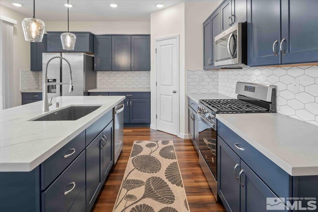7192 Discovery Ln, Reno, NV 89506 - kitchen with stainless steel appliances, a sink, dark wood finished floors, recessed lighting, and decorative light fixtures