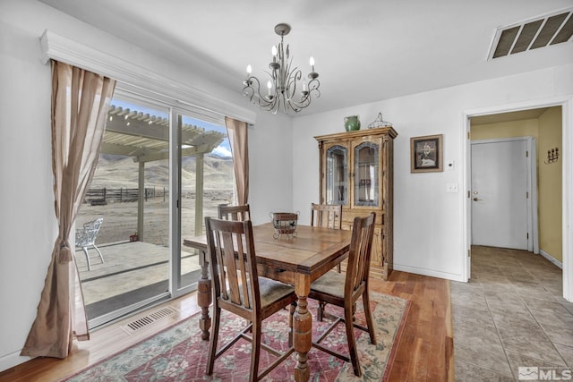 6100 Sage Flat Rd, Reno, NV 89510 - dining area with a chandelier, baseboards, and light wood-style flooring