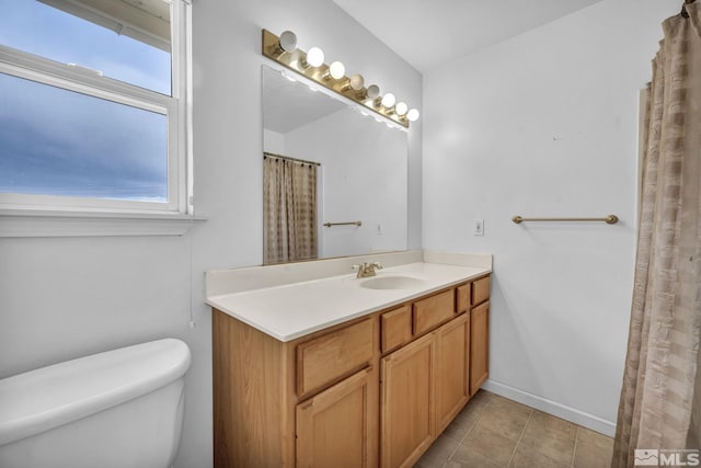 6100 Sage Flat Rd, Reno, NV 89510 - bathroom featuring toilet, vanity, tile patterned floors, and baseboards