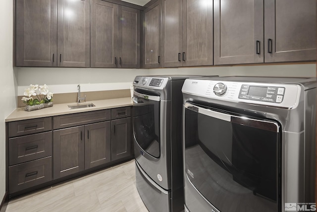 laundry room featuring washing machine and clothes dryer and cabinet space