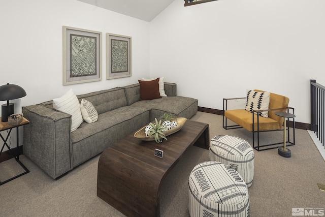 carpeted living room featuring lofted ceiling and baseboards