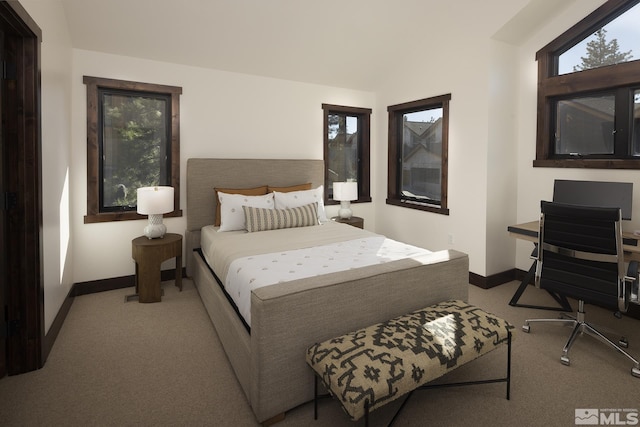 bedroom featuring carpet flooring, baseboards, and vaulted ceiling