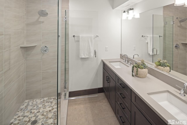 bathroom with a stall shower, tile patterned flooring, and double vanity
