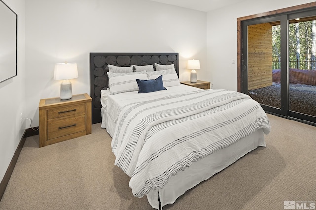 bedroom featuring light carpet, baseboards, and access to exterior