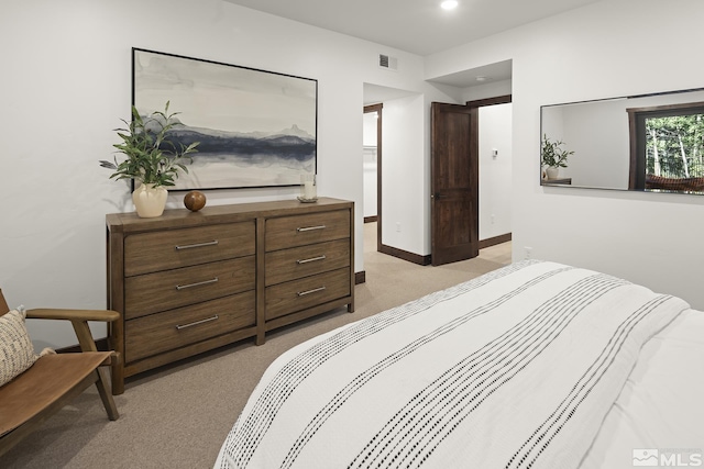 bedroom with light colored carpet, recessed lighting, and baseboards