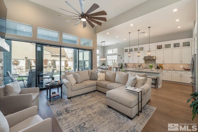 721 Marewood Trl, Reno, NV 89511 - living area featuring ceiling fan, light wood finished floors, a towering ceiling, and recessed lighting