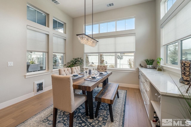 721 Marewood Trl, Reno, NV 89511 - dining room with wood finished floors, baseboards, a high ceiling, and a chandelier