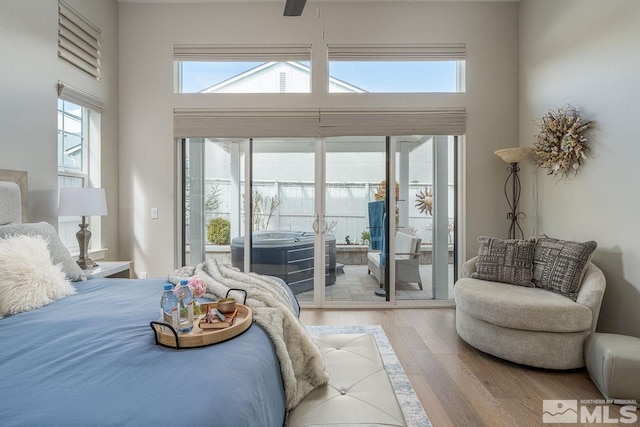 721 Marewood Trl, Reno, NV 89511 - bedroom with access to exterior, wood finished floors, and a towering ceiling