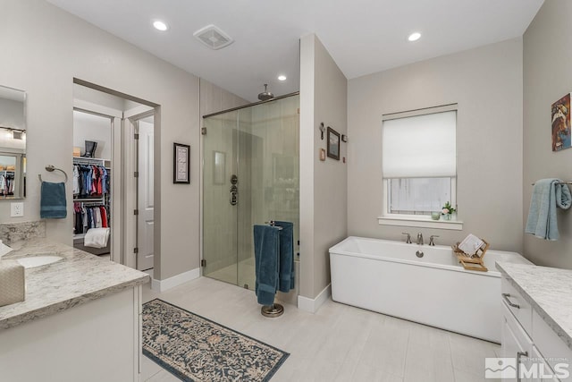 721 Marewood Trl, Reno, NV 89511 - full bath with a shower stall, vanity, a soaking tub, a walk in closet, and recessed lighting