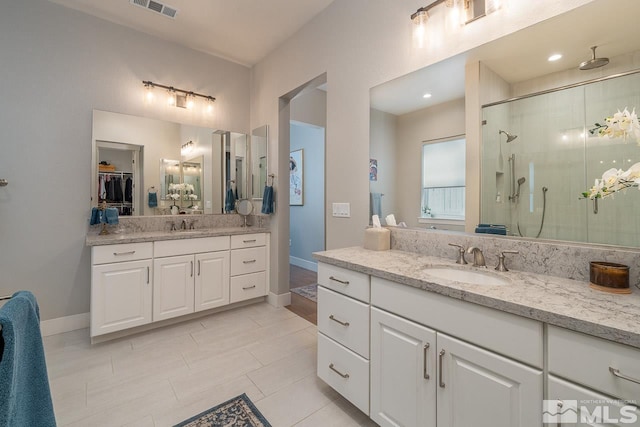 721 Marewood Trl, Reno, NV 89511 - full bath with a shower stall, two vanities, baseboards, and tile patterned floors