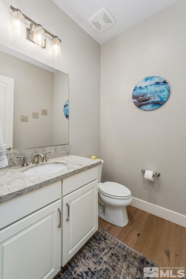721 Marewood Trl, Reno, NV 89511 - half bath featuring wood finished floors, toilet, vanity, and baseboards