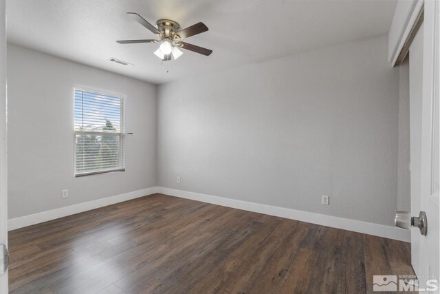 9447 Canyon Meadows Dr, Reno, NV 89506 - spare room featuring a ceiling fan, dark wood finished floors, and baseboards