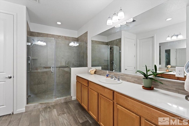 9820 Hafflinger Ln, Reno, NV 89521 - full bath featuring a stall shower, vanity, wood finished floors, and recessed lighting