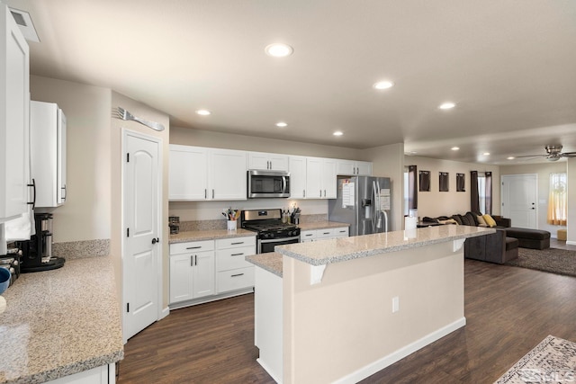 1953 Verona Dr, Fallon, NV 89406 - kitchen with appliances with stainless steel finishes, open floor plan, a center island, recessed lighting, and white cabinetry