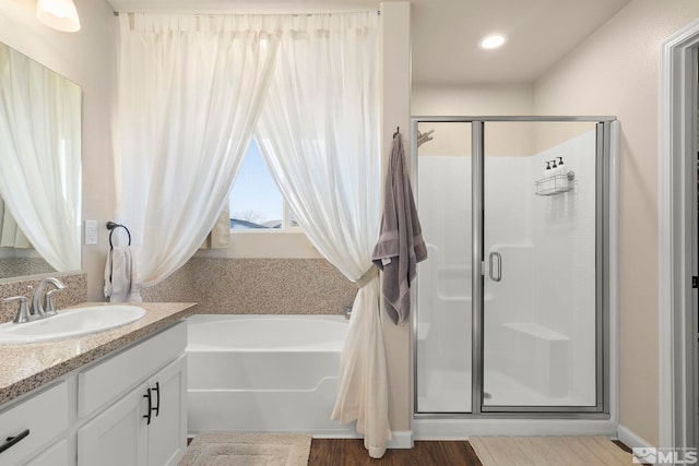 1953 Verona Dr, Fallon, NV 89406 - full bath with vanity, a stall shower, a garden tub, recessed lighting, and wood finished floors
