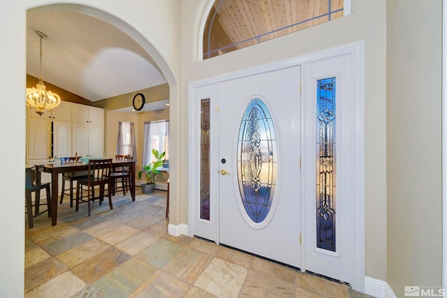 1253 Briggs Ln, Fallon, NV 89406 - foyer entrance with lofted ceiling, a chandelier, healthy amount of natural light, arched walkways, and baseboards