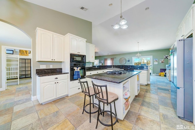 1253 Briggs Ln, Fallon, NV 89406 - kitchen with black appliances, stone tile floors, a peninsula, white cabinetry, and crown molding