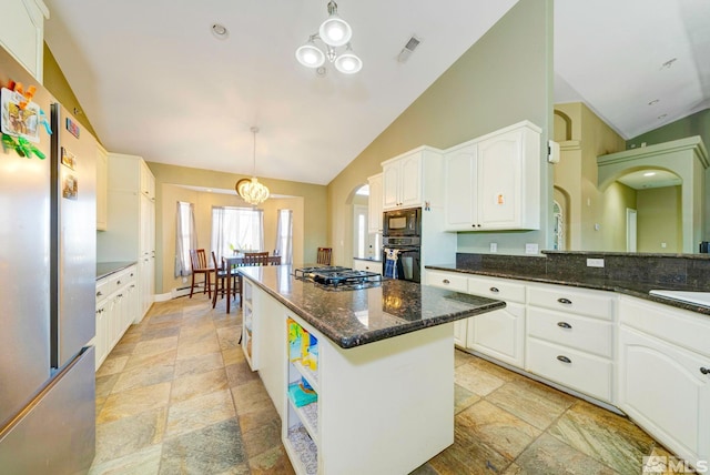 1253 Briggs Ln, Fallon, NV 89406 - kitchen with black appliances, stone tile floors, white cabinets, a kitchen island, and dark stone counters
