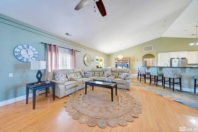 1253 Briggs Ln, Fallon, NV 89406 - living area with a ceiling fan, lofted ceiling, light wood-style flooring, baseboards, and arched walkways
