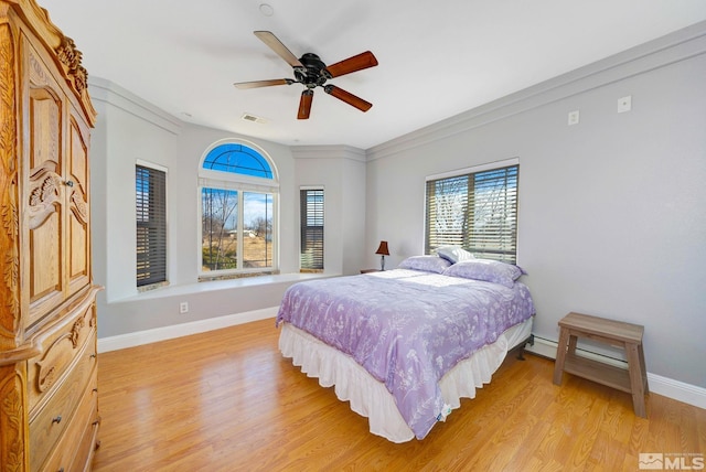 1253 Briggs Ln, Fallon, NV 89406 - bedroom featuring light wood-style floors, baseboards, crown molding, a baseboard radiator, and ceiling fan