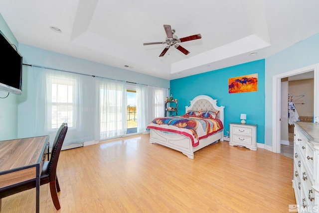 1253 Briggs Ln, Fallon, NV 89406 - bedroom with a tray ceiling, access to exterior, and light wood-type flooring